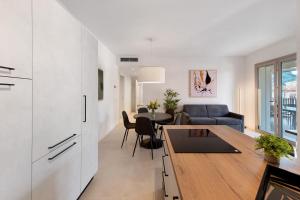 a kitchen and living room with a couch and a table at Residence Eleonora in Garda