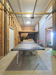a ping pong table in the middle of a room at Paradise Vibes in Bolivar Peninsula