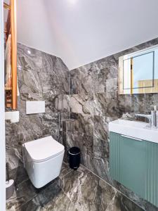 a bathroom with a toilet and a sink at Escape to Broadstairs in Broadstairs +52 photos