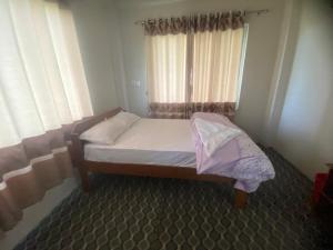 Ένα ή περισσότερα κρεβάτια σε δωμάτιο στο River Tiger Homestay