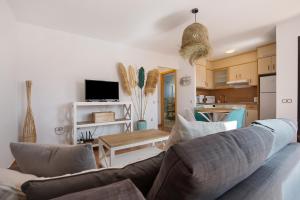 a living room with a couch and a table at Sunny Home in Lajares