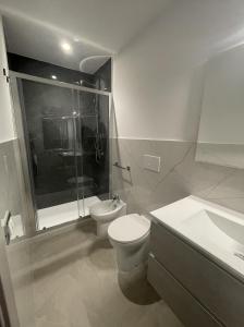 a bathroom with a toilet and a shower and a sink at Pesco Rooms Marineo in Marineo +19 photos