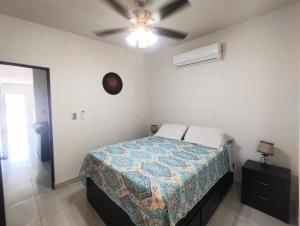 a bedroom with a bed and a ceiling fan at DOLPHIN Maeva Residencial in Puerto Peñasco +45 photos
