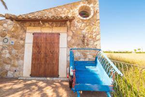 a blue cart parked in front of a building at Can Cap de Bou by Alquilair in Pollença