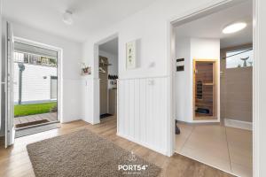 a hallway with white walls and a sliding glass door at Ferienwohnung Strandgut Olpenitz in Olpenitz