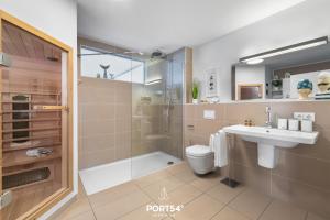 a bathroom with a shower and a toilet and a sink at Ferienwohnung Strandgut Olpenitz in Olpenitz +24 photos