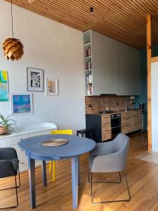 a dining room with a blue table and chairs at Train Home #3 in Pakopi