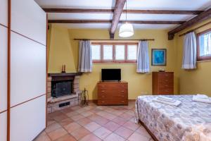 a bedroom with a bed and a fireplace at Casa Parco dell'Elsa in San Marziale
