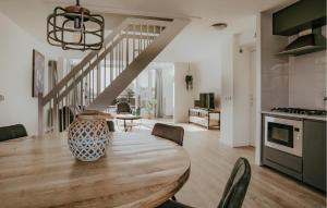 a kitchen and dining room with a table and chairs at Oostergeest 3 6P in Uitgeest