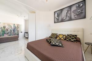 a bedroom with a large bed with pillows on it at Villa Leon with Private Pool in Quartu SantʼElena +29 photos