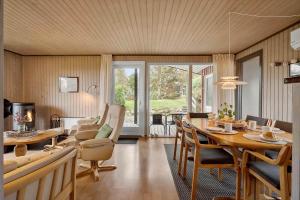 a living room with a table and a dining room at LL258-Humble-Paradisvejen-11 in Østerskov