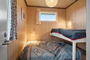 a bedroom with a bunk bed in a small room at LL258-Humble-Paradisvejen-11 in Østerskov