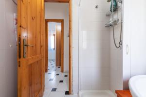 a bathroom with a shower and a toilet and a sink at La Casa di Silvia in Costa Rei +18 photos