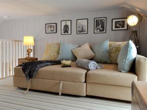 a living room with a couch with pillows on it at Manor Cottage in Bow +12 photos