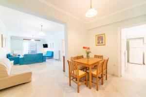 a living room and dining room with a table and chairs at St Nicholas A1 Beach Superior Two I in Dafnila