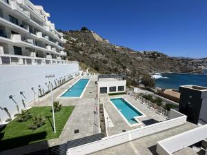 a view of a building with a swimming pool at Icon Marina A in La Herradura
