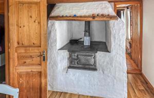an outdoor stove in a room with a door at Gorgeous Home In Gränna With Lake View in Bjällebäck