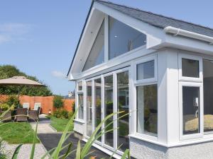a extension to a house with sliding glass doors at Benlli in Aberdaron