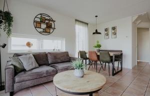 a living room with a couch and a table at Busch & Dam in Uitgeest