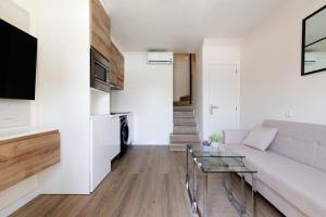 a living room with a couch and a glass table at Oasis Pool View in Maspalomas