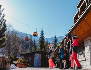 a group of people standing on a ski lift at Hotel Grand Jasná in Demanovska Dolina