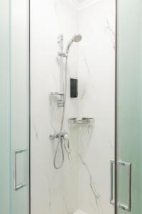 a bathroom with a shower with a glass door at Hotel Estia in Finikounta +32 photos