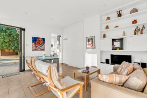 a living room with a couch and a tv at Alfonsa in Pollença