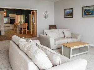 a living room with a couch and a table at Gleaner Lea Apartment in Campbeltown