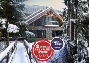 a sign in front of a house in the snow at Hotel Tri Studničky - Adult friendly in Demanovska Dolina