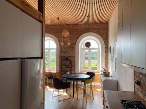 a kitchen and dining room with a table and chairs at Train Home #3 in Švenčionėliai