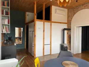 a living room with a loft bed and a table at Train Home #3 in Pakopi +2 photos