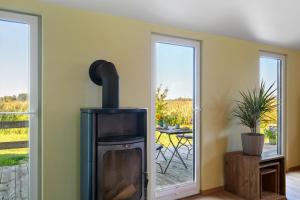 a living room with a wood stove and a patio at Ferienhaus Im Teichland Linum in Fehrbellin