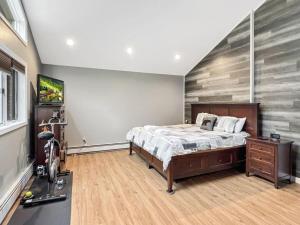 a bedroom with a bed with a wooden floor at Sugar Hollow in Mendon