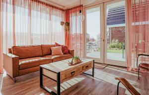 a living room with a couch and a coffee table at Saskerlei in Uitgeest