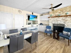a kitchen with a table and chairs and a fireplace at Admiral's Quarters in Wells Beach