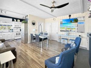 a living room with a kitchen and a dining room at Admiral's Quarters in Wells Beach