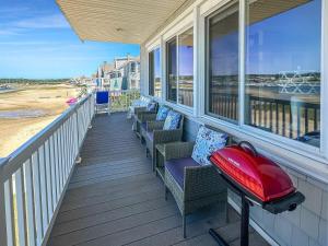 a balcony with chairs and a view of the beach at Admiral's Quarters in Wells Beach