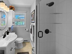 a white bathroom with a sink and a toilet at Admiral's Quarters in Wells Beach +15 photos
