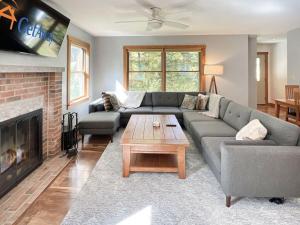 a living room with a couch and a fireplace at Hidden Kingdom in Tyson