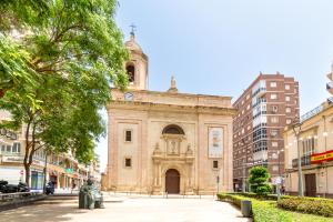 ein altes Gebäude mit einem Uhrturm in einer Stadt in der Unterkunft Casa Maruchi - Apartamento in Almería