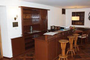 a kitchen with a bar with stools in a room at Hotel Weisses Kreuz in Interlaken