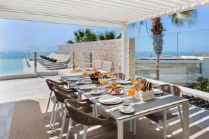 a dining room with a table and chairs on a patio at Karat Villa Zambrano in Tejina de Isora
