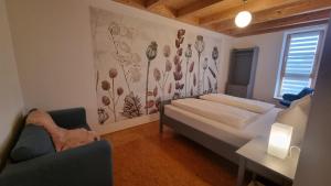 a bedroom with a bed and a desk and a chair at Ferienwohnung Stützenmühle in Haßfurt