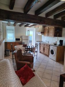 a kitchen and living room with a table and chairs at Gite La Nobleterie - 4 personnes Zoo de Beauval 35min in Frédillé