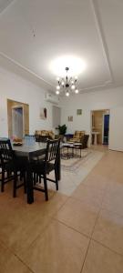a large living room with a table and chairs at شقة عائلية مودرن 4 غرف نوم رقم 1 in Quai
