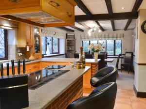 a large kitchen with black chairs and a counter at Lambourne House - Ukc2831 in Winthorpe +49 photos