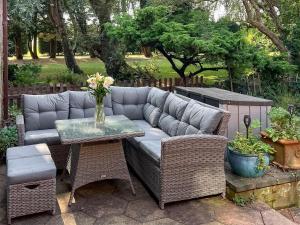 a patio with a couch and a table and chairs at Lambourne House - Ukc2831 in Winthorpe