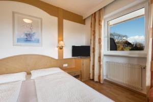 a bedroom with a bed and a window at Residence Kronstein - Fewo 3 in Tesimo