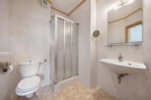 a bathroom with a toilet and a sink at Residence Kronstein - Fewo 3 in Tesimo +8 photos