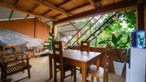 a dining room with a wooden table and chairs at Lion Wood Treehouse in Talkote